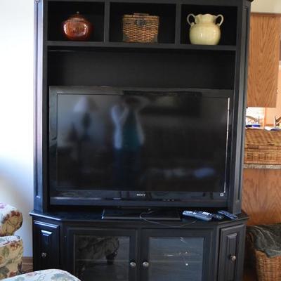 Black entertainment center with Sony flat screen TV 