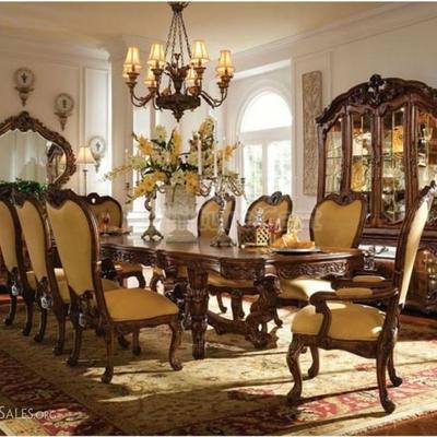 Designer Michael Amini 8 piece dining set from the Palais Royale collection, with dining table and 8 chairs in Rococo Cognac finish
