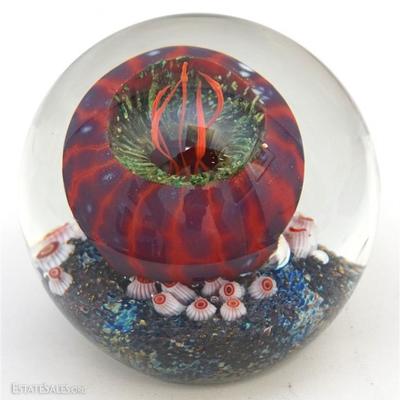 Lot 185- A Rick Satava Glass Paperweight. Containing a stylized anemone on the interior. Underside is signed and numbered 