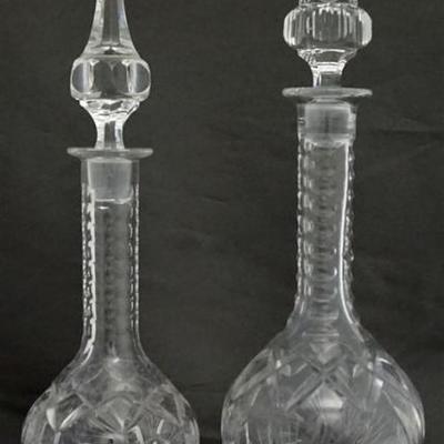 A pair of EAPG Decanters in a Pinwheel and Hobstar with wonderful elongated stoppers. One measures 17