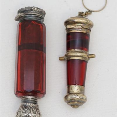 Lot 126 - Two English Victorian Cut Ruby Glass Double Ended Scent Bottles Both of these bottles were meant to hold perfume at one end,...