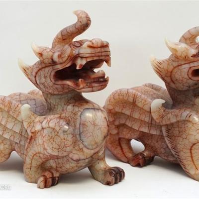 Lot 138 - A Large 19th c. Pair of Carved Chinese Red Jade Nephrite Mythical Pixiu. Each depicted on all fours with tail curled by back...