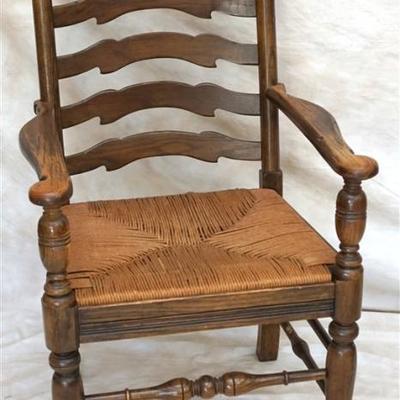 Lot 324 - Antique English oak ladder back armchair, the arched bars between turned supports, above a hand woven rush seat, on turned legs...