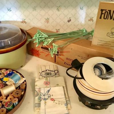 Sharp microwave and vintage kitchen items/home decor, including canisters,  serving ware, utensils, fondue set, crock pot, glasses, and...