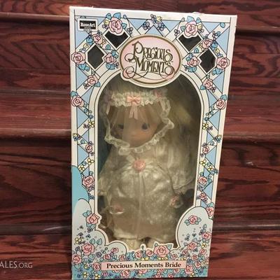 Precious Moments Bride. This dolls comes in packaging but has definitely been removed at one point in time. 