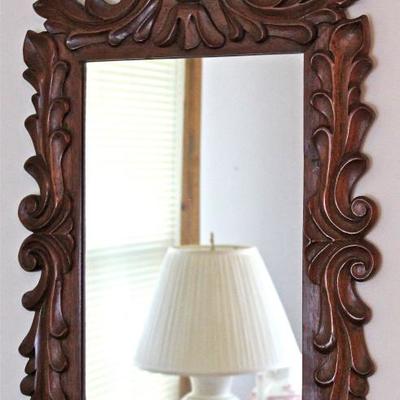 ornately carved wood frame mirror