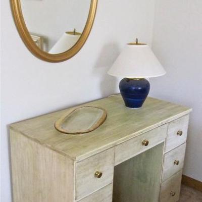 Desk, lamp, gold framed mirror, glass platter
