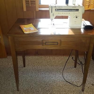 Singer Stylist sewing machine, and table. Table drawer is full of sewing notions, and they go with purchase