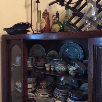 This glass front cabinet and lots of dishware still avail