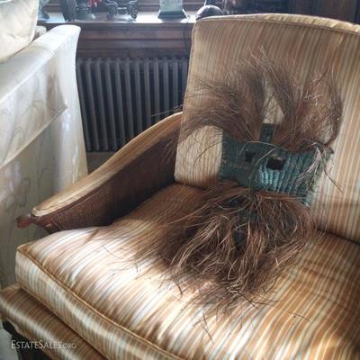Detail of Mid-Century armchair and funny vintage woven grass mask