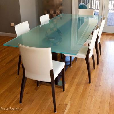 Glass top dining table, with wood and metal base. Table measures 94.5