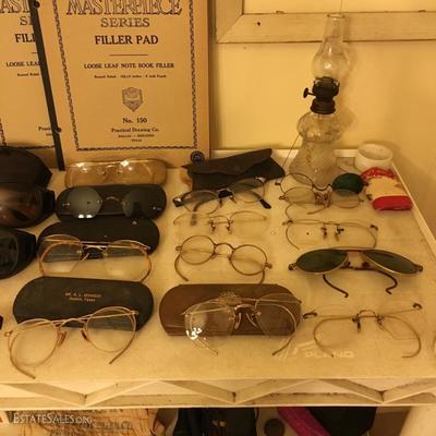 Many pairs of antique and vintage glasses