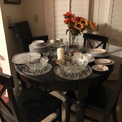 Table with 4 chairs and leaves.  
Great serving pieces and China on top