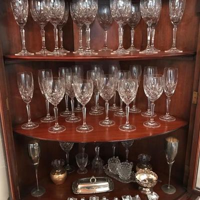 Antique corner display hutch with unique rounded front.