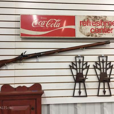 Coca-Cola sign and black powder wall hanger