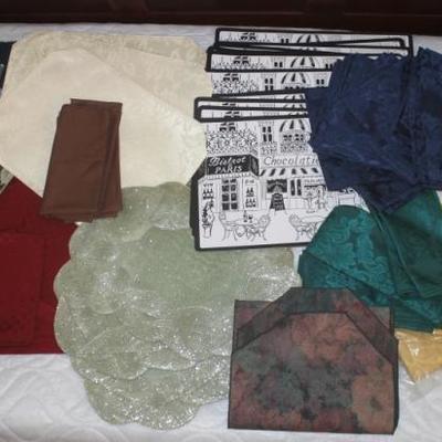 Box lot of many place mats, napkins, tablecloths and runners, and napkin rings
