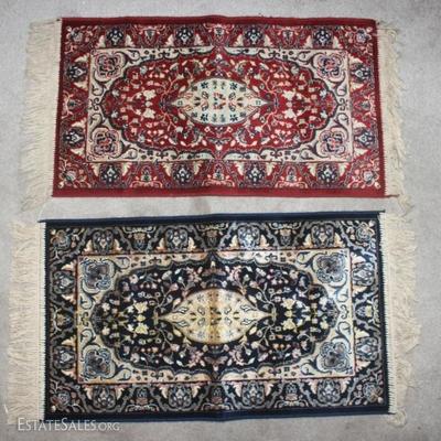 Set of two machine made doormat sized rugs
