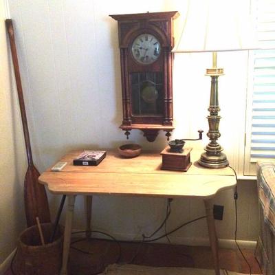 Drop leaf table, lamp, antique coffee grinder, antique wall clock, butter churn bucket, oar