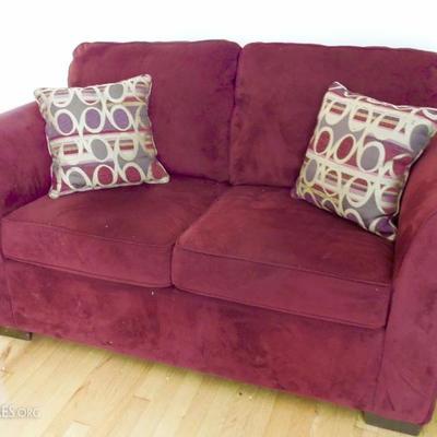 Brushed cloth garnet colored love seat with throw pillows. (Matching couch not pictured)