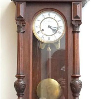 Vintage Carved Wood Regulator Clock. Beautifully Carved Mahogany Wood Case. The clock has a porcelain enameled face that has 