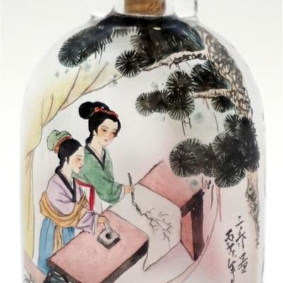 A good 20th c. Peking glass snuff bottle with very fine reverse painted decoration of geisha in a landscape, signed with calligraphy....