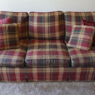 A plaid couch with a pull out bed. In good condition. 