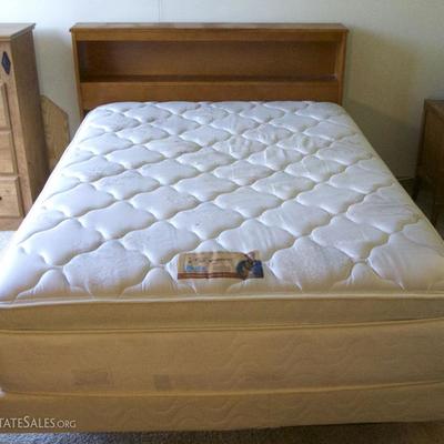Full size bed with frame and mattress.
