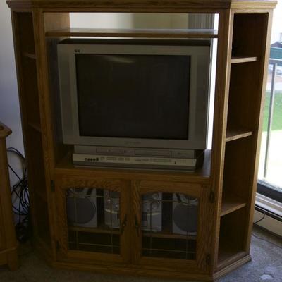 Entertainment center with working TV and stereo system. 