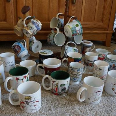 Large assortment of coffee mugs and two coffee mug racks.