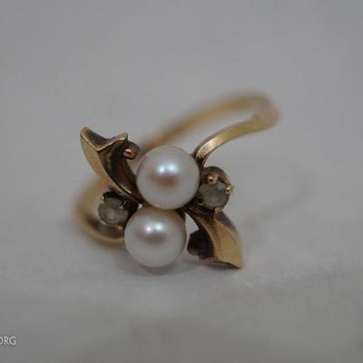 This is a 10k gold pearl cocktail ring that is signed Resco. We believe the diamonds are real however they are not confirmed. 