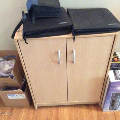 cupboard, computer programs and cd cases