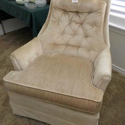One of two matching neutral swivel chairs