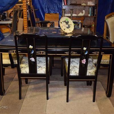 Oriental dining table with 8 chairs and 2 leaves.  Glass top 