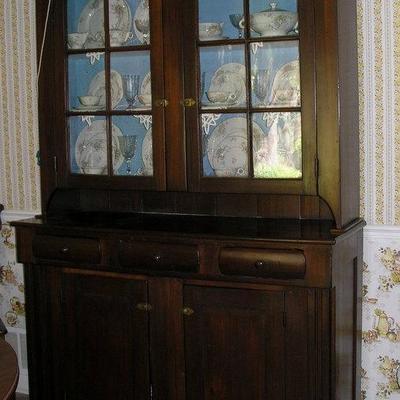 Large Primitive Walnut Kitchen Cabinet included in a Photo of the Governors home below 