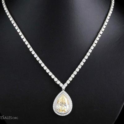Appraised Retail Value: $240,000. Asking: $130,000 Platinum/18K gold - 8.94 ct pear shape yellow diamond pendant set with 0.95 cts tw of...