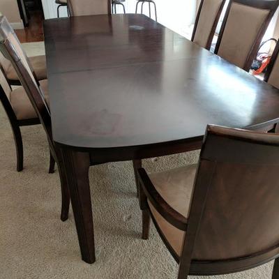 Dining Room table with two leaves and eight padded chairs.