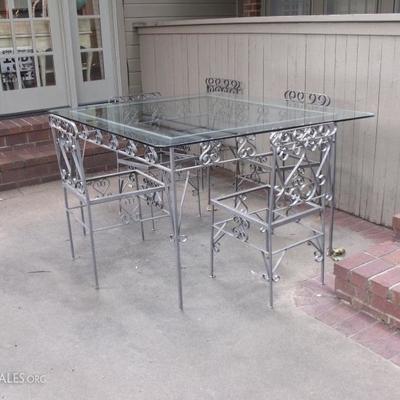 Glass top patio table with 5 chairs.