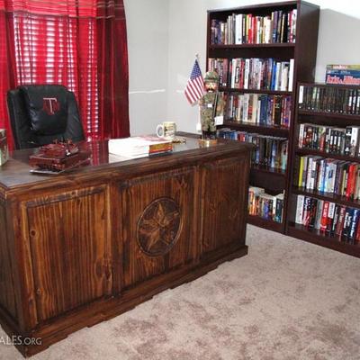 Texas Lone Star Medallion Solid Pine Executive Desk (66"W x 29"D x 32"H).  Also shown are wooden bookcases full of...