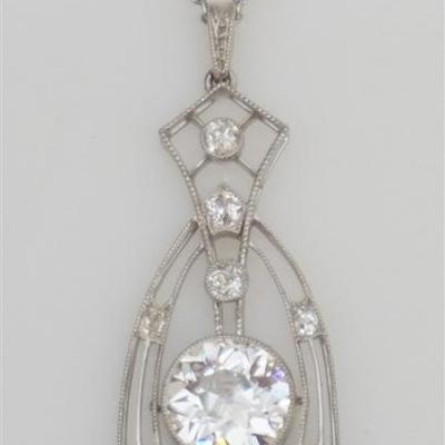 Lady's 18kt white gold and platinum diamond necklace. The necklace has a stunning pendant a the center of a 