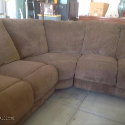 light brown sectional has recliner on both ends