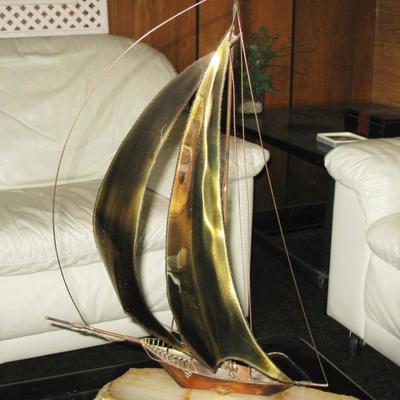 brass sailboat on marble 