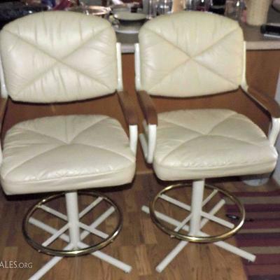 Set of two Douglas furniture metal frame counter stools with leather seat/back and wood armrests.