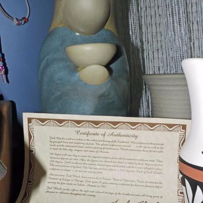 Signed Jack Black Pottery Sculpture of Native American Woman holding a bowl.  Certificate of authenticity is included.  