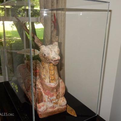 Lot # 101 /   Bali late 19-20 century Funerary statue of a kneeling horned animal. Carved wood and polychrome in the wood saddle is a...