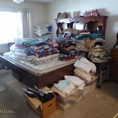 Full bedroom with many blankets and quilts