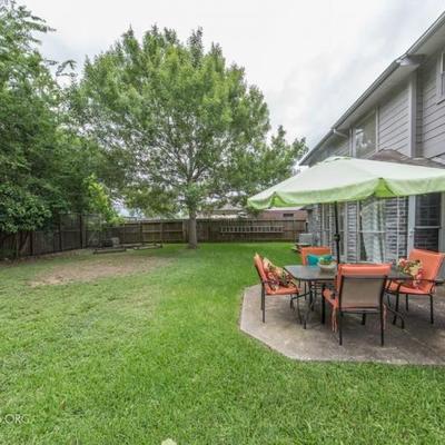 Backyard with Patio Set: Umbrella, Rectangular Glass Top Table with 4 Arm Chairs 
