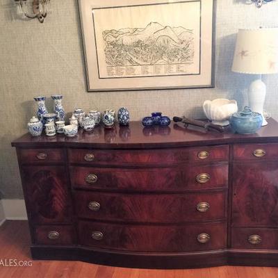 Sideboard buffet with matching table and china cabinet. Lots of blue and white china and dishes.