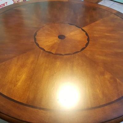 Circular dining table with metal base