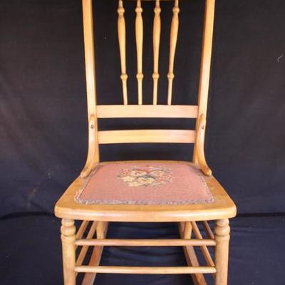 Vintage Rocking Chair: Wooden chair with needlepoint seat cushion cover and spindled back.  38
