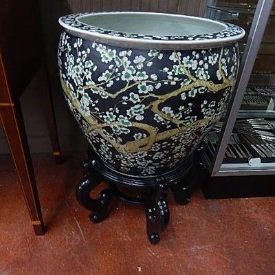Oriental fish bowl on wood stand
